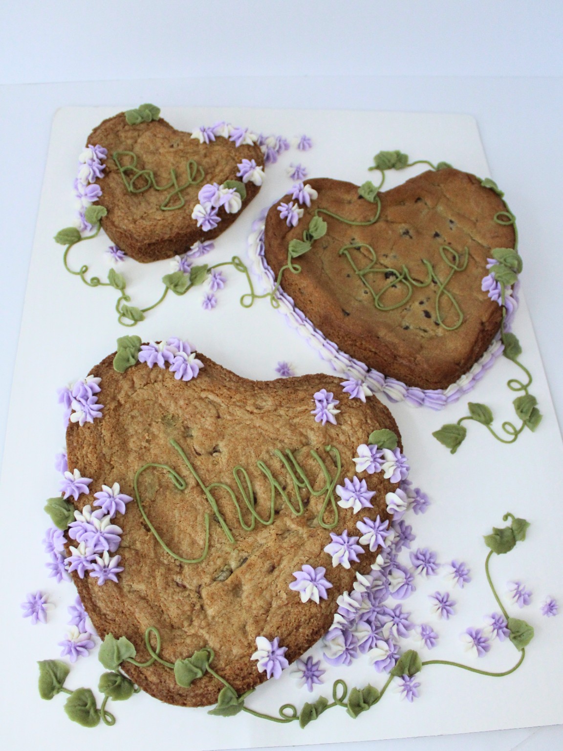 Heart-shaped cookie cakes decorated with purple flowers and green vines