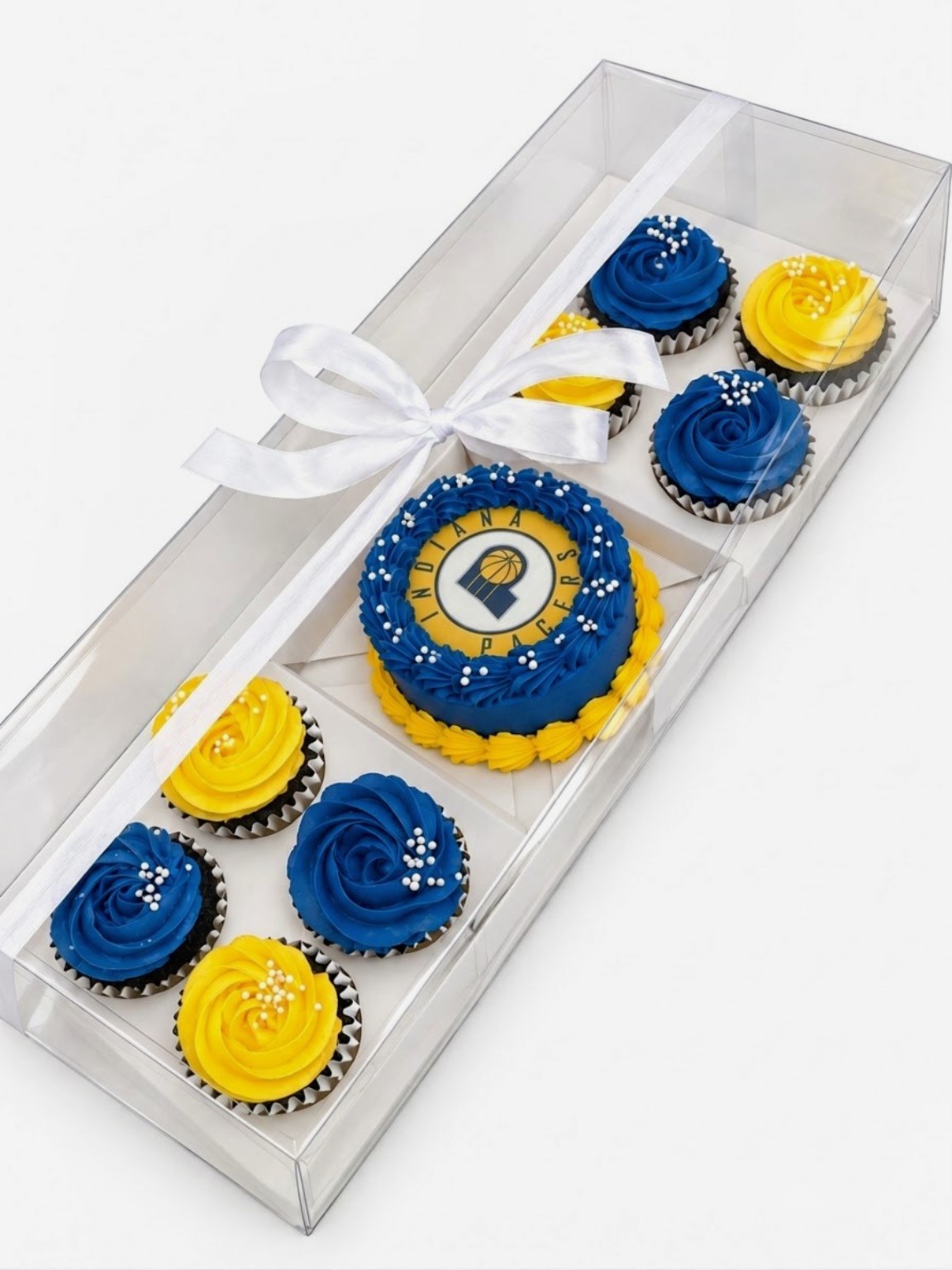 Sweet set with a mini cake and coordinating cupcakes in a clear gift box